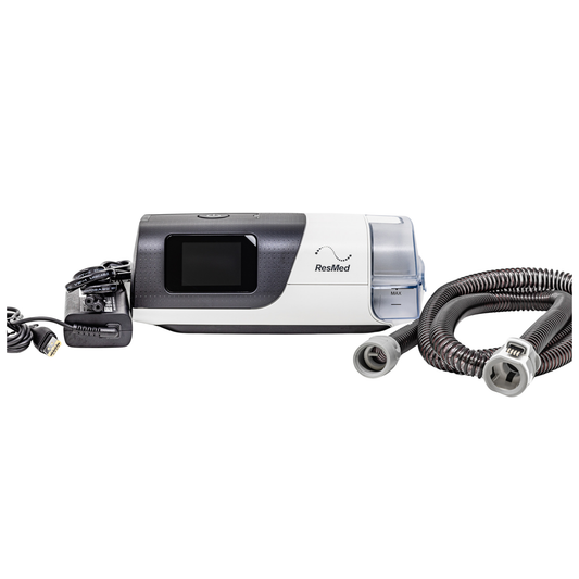 ResMed CPAP machine with hoses on a white background